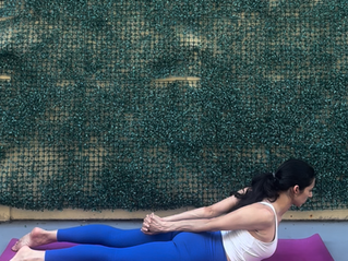 Elisha in Locust Pose (Salabhasana), lying prone with chest, arms, and legs lifted off the mat simultaneously
