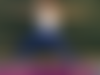 Elisha in Warrior 2 (Virabhadrasana II), arms extended wide, front knee bent, gaze over front fingertips