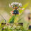 Thumbnail: A macro shot of a clover flower and a spiderweb in a bright, grassy field with a blurred background.