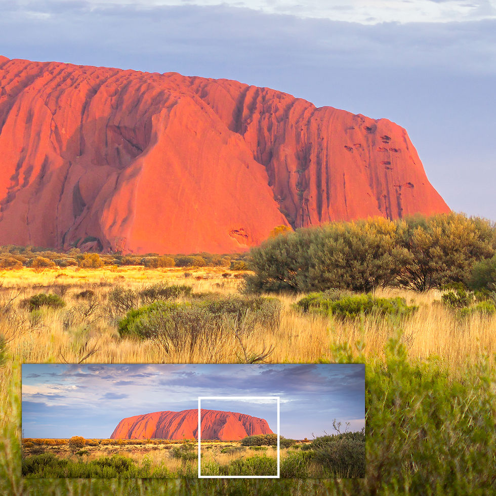 Close-up of metallic glass print showing Uluru rock texture and vibrant red tones