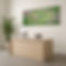 Angled view of a reception desk with computer and plant, topped by a long landscape print of an Eastern Yellow Robin on barbed wire.