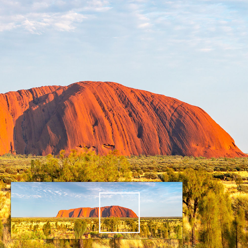 Close-up of metallic glass print showing Uluru rock texture and vibrant red detail