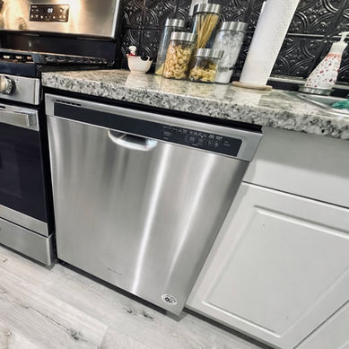 Dishwasher and surrounding kitchen cabinets after cleaning