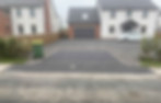 Photo of a commercial/domestic project: Construction of a vehicle crossing to LCC specifications, including a hardstanding driveway area to prevent gravel from migrating onto the highway.