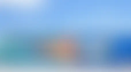 Colorful mural titled “Wave of Lace” featuring a large stylized hand reaching toward a white flower, surrounded by intricate lace-like patterns and geometric designs in shades of blue, teal, and coral, part of the Walls for Women project in Tennessee.