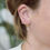 Thumbnail: Waterproof gold star Huggies earrings 
