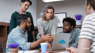 a group of people around a laptop integrating AI in cloud