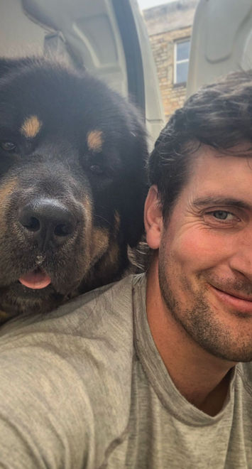 man and dog close up looking at camera