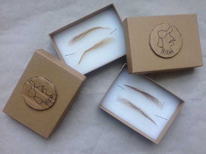 Picture of trucho's packaging. The boxes are open and you can see to sets of wig eyebrows inside.