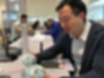 Me Examining Pair of Doucai Bowls, at Sotheby's