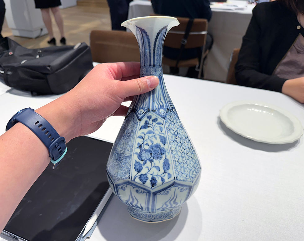 Anthony Wu examining a rare Chinese Yuan Dynasty blue and white bottle vase at Christie's New York during Asia Week September 2025