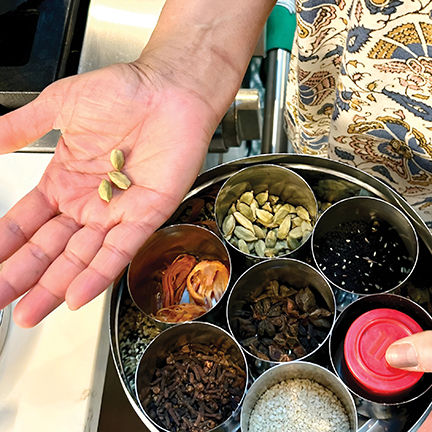 Rajan uses whole and ground spices from her masala dabba, a spice storage container widely used in Indian kitchens