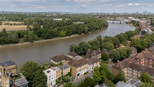 drone shot of a river side house in Mortlake, London