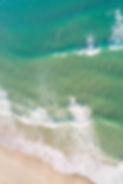 drone aerial directly above view of the shore of a beach with turquoise waters.jpg
