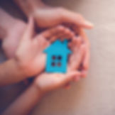hand holing paper cutout of house