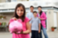 young girl holding piggy bank, family watches