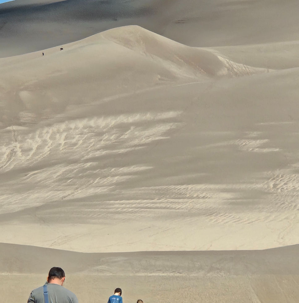 people walking towards Great Sand Dunes NP in Colorado on a sunny day