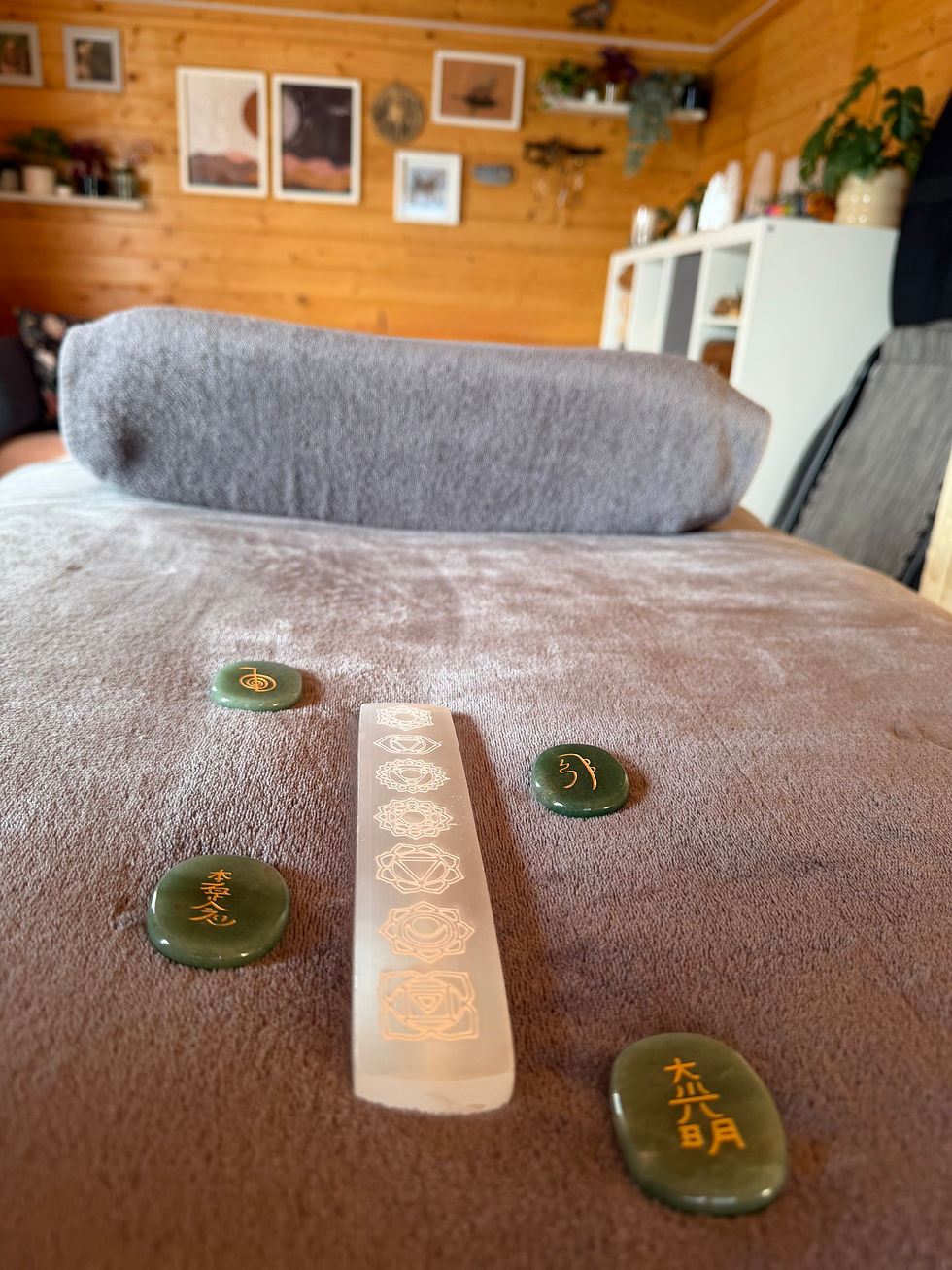 Reiki treatment couch with selenite chakra wand and Reiki stones in the Essential Energies treatment room