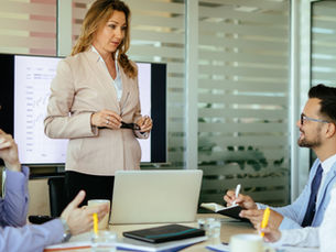 Professional taking initiative and ownership of their growth by leading a discussion in a workplace setting