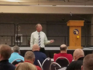 Ian Gregory working with leaders and demonstrating the importance of developing employees through coaching and conversation.