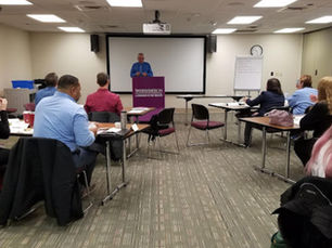 Leadership instructor discussing the responsibilities of leadership with participants during a professional development workshop.
