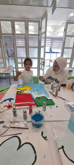 child paints a mural