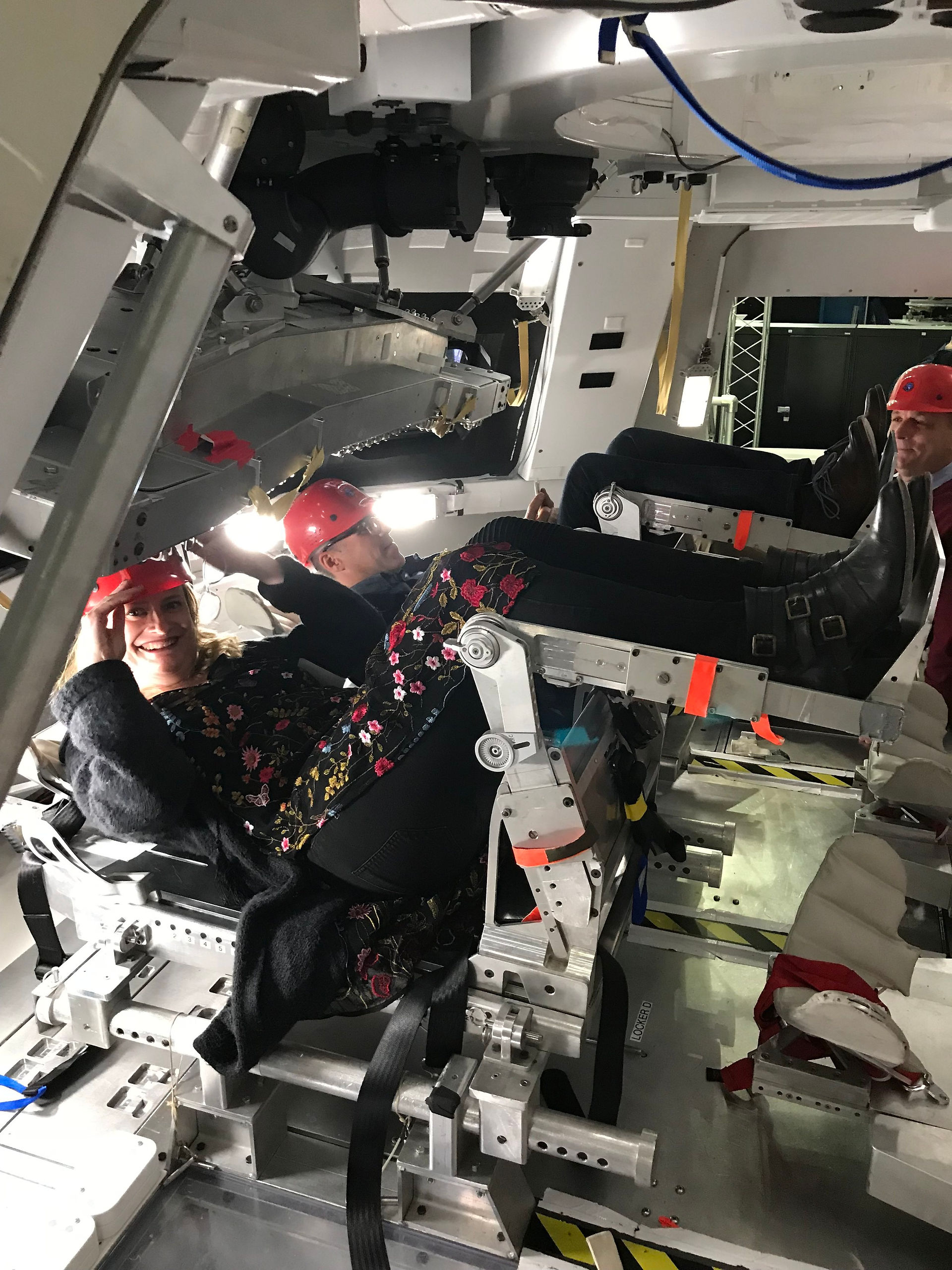 Mellissa Menta and Chris Bracco seated horizontally in the shuttle chairs