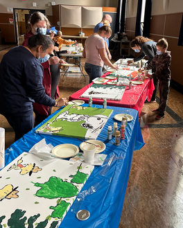 doctors and children in face masks paint murals