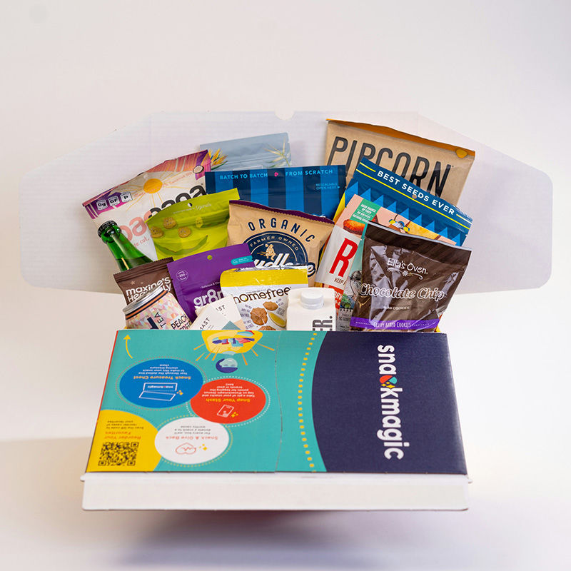 Open food gift box filled with snacks and popcorn, a Christmas gift box idea for couples
