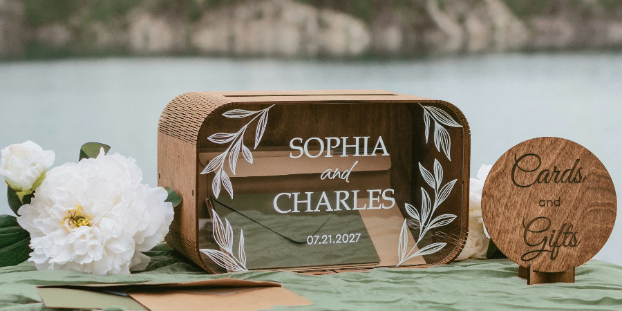 Personalized wooden wedding card box with an engraved acrylic front showing the couple's names and wedding date