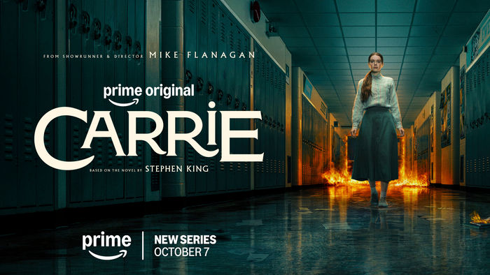 Official Carrie key art: a girl in a long dark skirt stands in a school hallway as flames burn along the floor. Prime Video, October 7.