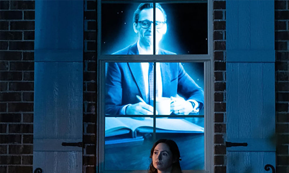 The Life of Chuck scene showing a man appearing on a television screen through a window.