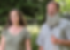 White woman and man standing in the woods