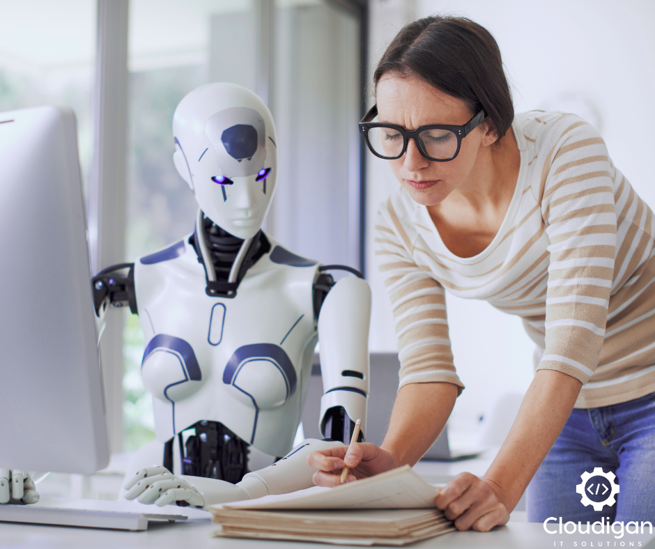 Woman reading documents beside a humanoid robot in a modern office. The atmosphere is focused. Logo reads "Cloudigan IT Solutions."