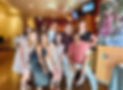 Diverse male and female members of the Auxiliary Board at a restraunt during a fundraising event.