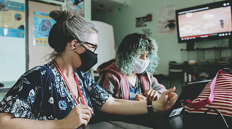 Female Association House High School staff working with a student.