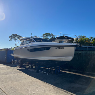 Sealine S330 yacht with black registration lettering on wrapped hull