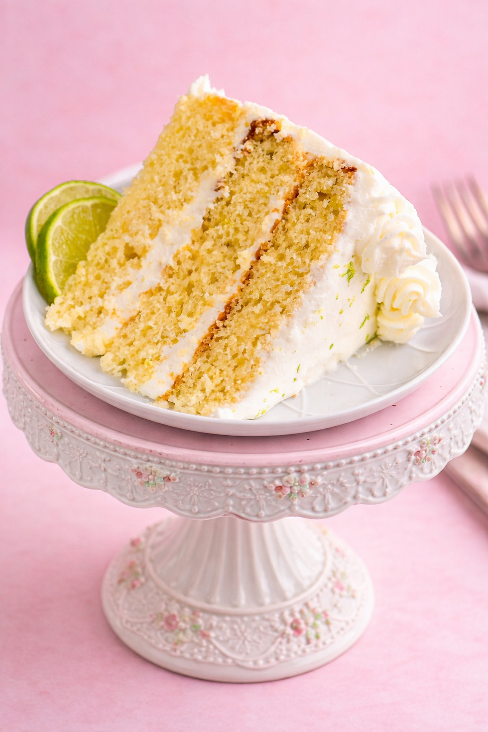 Lime cake on ornate stand.png