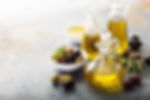 Olive oil bottles and olives