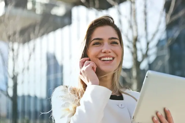 Chica hablando por smartphone y sosteniendo una tablet