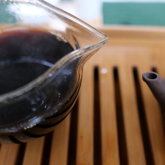 pouring pu-erh tea from a glass pitcher
