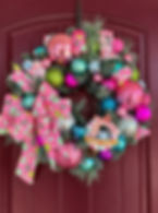 Colorful Christmas wreath with pink, blue, and lime ornaments