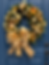 Gold Christmas wreath with ornaments on a blue door