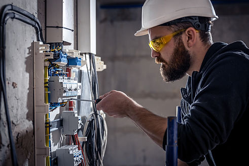 male-electrician-works-switchboard-with-electrical-connecting-cable (3).jpg