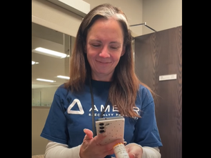 Smiling pharmacist uses the ScripTalk mobile app