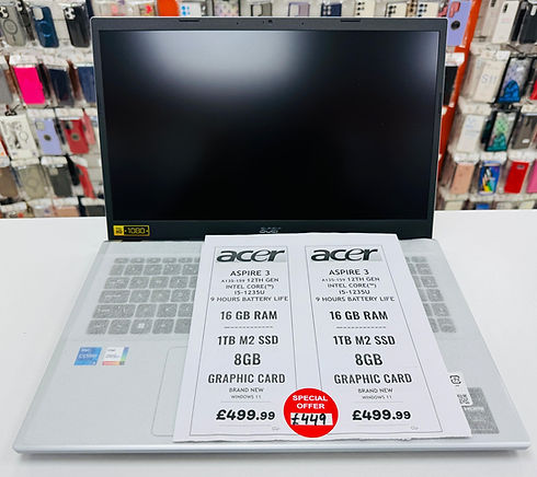 A silver Acer laptop with a black screen on display. Two spec sheets highlight 16GB RAM, 1TB SSD, and 8GB graphics, priced £499.99 with a special offer at £449