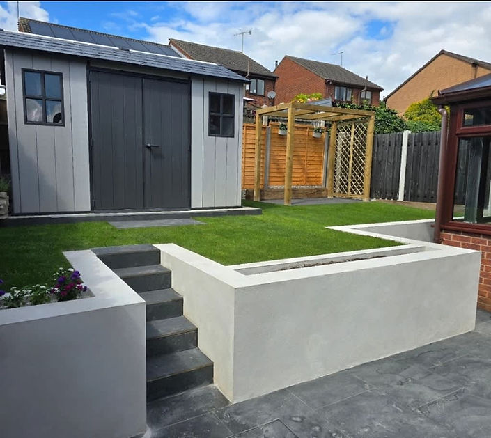 A modern garden features a small grey and black shed, and a grassy lawn