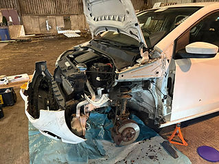 Car with open hood, disassembled parts