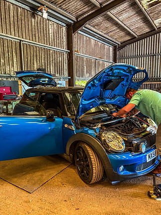 working on blue car