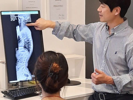 Chiropractor explains spinal x-rays to a patient